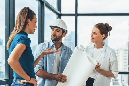 Photo for Group of architect engineer looking at project plan while brainstorming idea about building structure. Manager team discuss about building construction while standing near with city view. Tracery. - Royalty Free Image