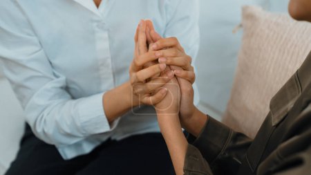 Photo for Supportive and comforting hands cheering up depressed patient person or stressed mind with empathy. Psychologist reassuring stressful and sad patient in vivancy clinic. - Royalty Free Image