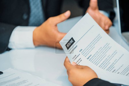 Photo for Human resources department manager reads CV resume document of an employee candidate at interview room. Job application, recruit and labor hiring concept. uds - Royalty Free Image