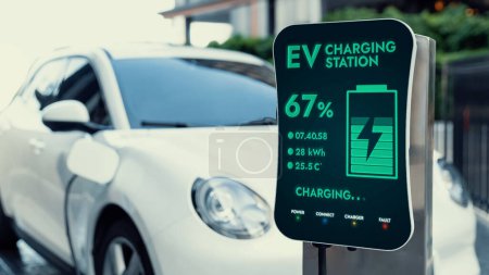 Photo for Futuristic clean energy utilization of smart EV charging station in residential area recharging electric cars battery. Technological advancement of high-tech EV car in modern city lifestyle. Peruse - Royalty Free Image