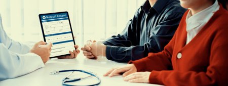 Photo for Couple attend fertility consultation with gynecologist at hospital as part family planning care for pregnancy. Loving husband and wife support each other through the doctor appointment. Panorama Rigid - Royalty Free Image