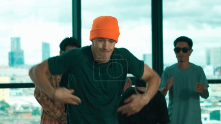 Photo for Group of multicultural hipster practice break dance with cityscape or sky scrapper view. Attractive people dancing together while moving body to music. Outdoor sport 2024. Blue filter. Endeavor. - Royalty Free Image