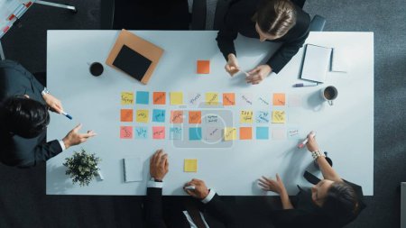 Photo for Top down aerial view of manager discuss and choose marketing idea from sticky notes. Group of business team talking and brainstorming strategy while making decision and choose plan. Directorate. - Royalty Free Image