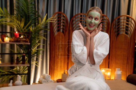 Photo for Serene ambiance of spa salon, woman customer indulges in rejuvenating with luxurious face cream massage with warm lighting candle. Facial skin treatment and beauty care concept. Quiescent - Royalty Free Image