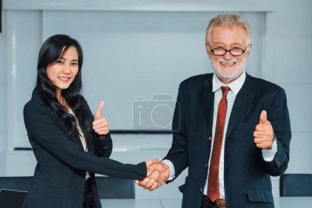 Photo for Senior executive manager and young businesswoman working in meeting room in the office. The woman is secretary or translator. International business language translation concept. uds - Royalty Free Image