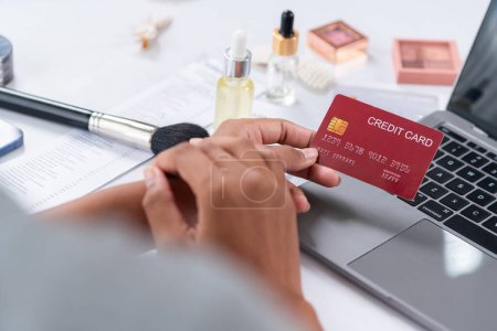 Photo for Close up credit card using for online payment, banking and shopping on the internet network with laptop computer showing credit card technology for online secured wallet top up and crucial purchase - Royalty Free Image