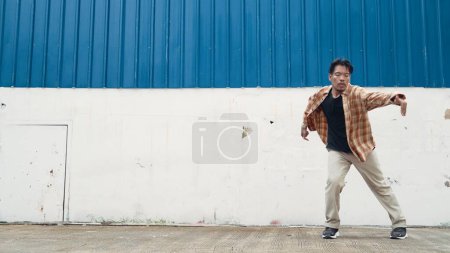 Photo for Hispanic funny choreographer dancing in hip hop style. Young happy break dancer perform b-boy dance. Motion shot of funny man practicing street dancing. Outdoor sport 2024. Modern dance. Endeavor. - Royalty Free Image