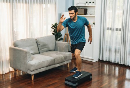 Photo for Athletic and sporty man running posture at home body workout exercise session for fit physique and healthy sport lifestyle at home. Gaiety home exercise workout training. - Royalty Free Image