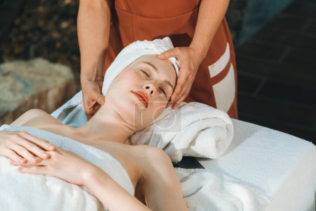 Photo for Attractive caucasian woman receive electrical facial treatment. Beautiful girl lies on spa bed while having medical treatment from professional doctor from medical spa center. Tranquility. - Royalty Free Image
