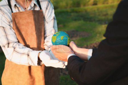 Photo for Eco-business company empower farmer with eco-friendly farming practice and clean agricultural technology. Cultivate sustainable future and holding Earth globe symbolize commitment to environment.Gyre - Royalty Free Image