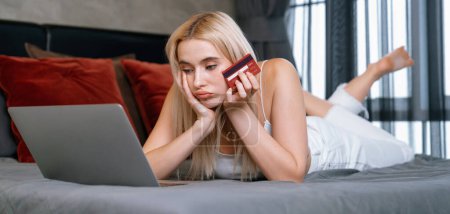 Photo for Stress worried young woman sit at table, as she pay bills online with credit card from financial debt problem, monthly expense and credit card debt. Over spending money problem. Panorama Blithe - Royalty Free Image