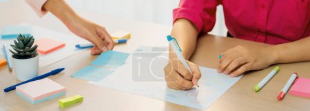 Photo for Professional businesswoman drawing business mind map. Creative female startup leader drafts marketing plans using pens and sticky notes to brainstorms idea. Closeup. Focus on hand. Variegated. - Royalty Free Image