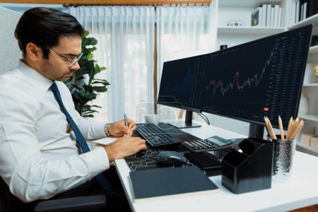 Photo for Smart trader businessman analyzing in two dynamic stock exchange investment screen on pc with investing highest profitable financial technology in searching market at modern home office. Surmise. - Royalty Free Image