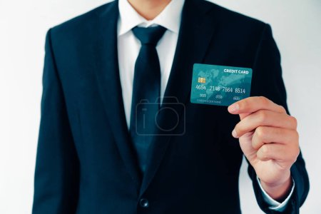Photo for Portrait of businessman holding a credit card showing front view to the camera in close up view. Online shopping business and cashless payment concept. uds - Royalty Free Image
