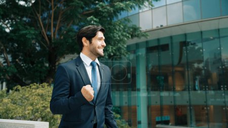 Photo for Successful business man celebrate getting a new position at building. Happy project manager smiling and proud about good news about successful project, winning prize, getting promotion. Exultant. - Royalty Free Image