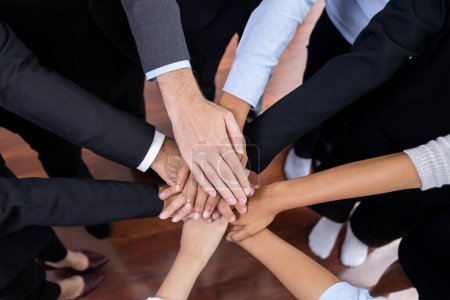 Photo for Multiracial business people make synergy hand stack together in meeting room as cooperation or team building for corporate employee in workplace. Meticulous - Royalty Free Image