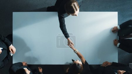 Photo for Top down aerial view of business team shaking hand to celebrate young businesswoman getting promotion. Diverse business people congratulate for successful project while hand shaking. Directorate. - Royalty Free Image