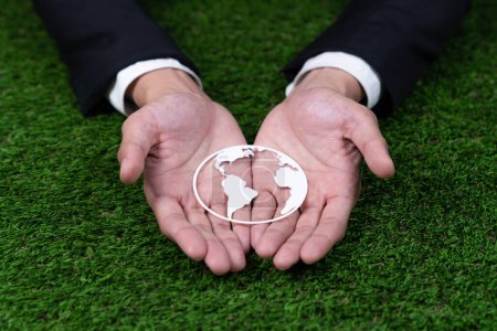 Photo for Businessman holding Earth planet icon symbolize eco-friendly business commitment to environmental protection and zero carbon emission. Earth World Day concept to promote eco awareness. Gyre - Royalty Free Image
