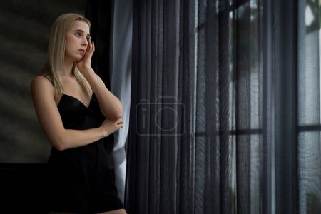 Photo for Young woman with critical depression and anxiety disorder from loneliness, mental sickness, or unwanted pregnancy, feeling lifeless on dark bedroom. Overwhelming negative thought and reclusive. Blithe - Royalty Free Image