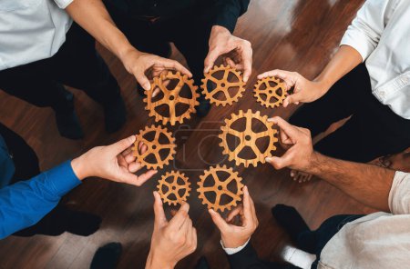 Photo for Business team joining cogwheel in circular together symbolize successful group of business partnership and strong collective unity teamwork in community workplace with productive efficiency. Prudent - Royalty Free Image