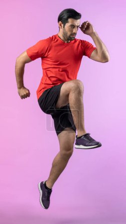 Photo for Full body length gaiety shot athletic and sporty young man fitness running cardio exercise posture on isolated background. Healthy active and body care lifestyle. - Royalty Free Image