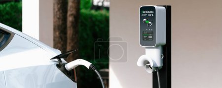 Photo for Electric vehicle technology utilized to residential home charging station for EV car battery recharge. Eco-friendly transport by clean and sustainable energy for future environment.Panorama Synchronos - Royalty Free Image
