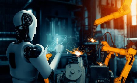 Téléchargez les photos : XAI Robot industriel mécanisé et bras robotisés pour montage en usine. Concept d'intelligence artificielle pour la révolution industrielle et l'automatisation des processus de fabrication. - en image libre de droit