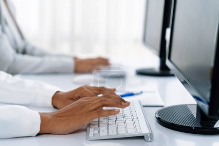 Photo for Close up shot of woman hands using desktop computer for crucial office working - Royalty Free Image