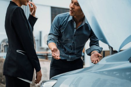 Photo for Man help woman fix the car problem. He pop up the car hood to repair the damaged part. uds - Royalty Free Image
