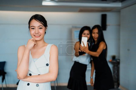 Photo for Young Asian businesswomen standing in office. Business friends and community concept. uds - Royalty Free Image