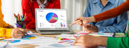 Photo for Startup company employee working together using laptop analyzing BI dashboard paper on financial data report and planning strategic marketing for business success in panorama banner. Synergic - Royalty Free Image