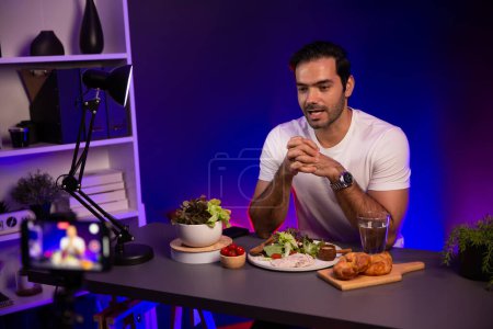 Photo for Healthy influencer in host channel presenting fresh vegetables in special dish of salad with brest chicken for easy cooking product by self with tasty food on social media live on meal time. Surmise. - Royalty Free Image