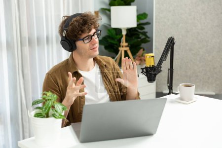 Photo for Host channel of influencer using headphone and mic talking with listeners on social media with laptop in life coaching and training marketing planning to customer target at studio office. Gusher. - Royalty Free Image