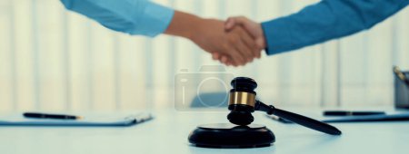 Photo for Businessman and corporate lawyer make successful deal with handshake in law firm office. Attorney and client achieving legal consultation and celebrating mutually beneficial partnership.Panorama Rigid - Royalty Free Image