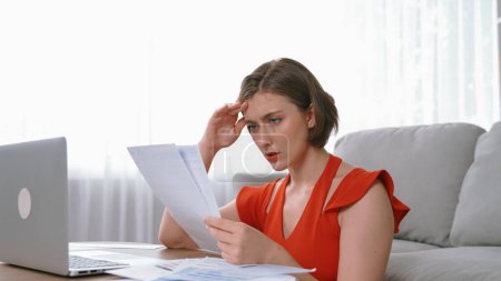 Photo for Stressed young woman has financial problems with credit card debt to pay prim from bad personal money and mortgage pay management crisis. Woman worry about financial bankruptcy risk from over spending - Royalty Free Image