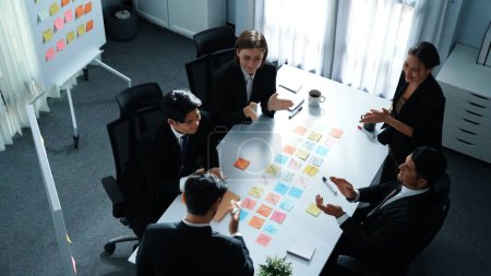 Photo for Top view of business people brainstorm idea by using sticky notes while planning marketing strategy at meeting room. Group of diverse team discuss about financial plan. Teamwork concept. Directorate. - Royalty Free Image