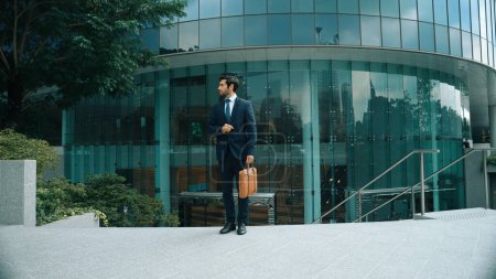 Photo for Skilled business man wearing formal suit while standing in urban city. Professional project manager standing in front of building while wearing formal suit. Office man finding for new job. Exultant. - Royalty Free Image