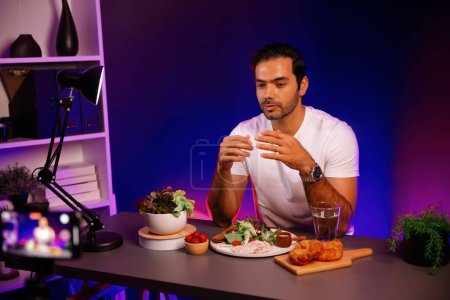 Photo for Healthy influencer in host channel presenting fresh vegetables in special dish of salad with brest chicken for easy cooking product by self with tasty food on social media live on meal time. Surmise. - Royalty Free Image