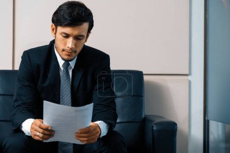 Photo for Stressed businessman candidate sit and wait for interview at the company office. Job application, business recruitment and Asian labor hiring concept. uds - Royalty Free Image