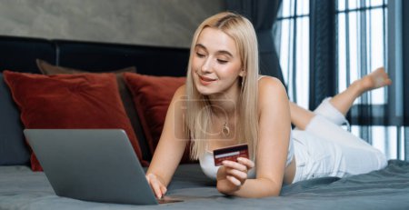 Photo for Young woman using laptop with credit card for internet banking, online shopping E commerce by online payment gateway at home office. Modern and convenience online purchase. Panorama Blithe - Royalty Free Image