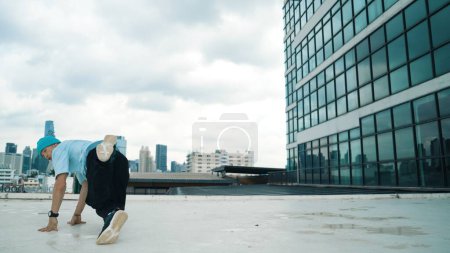 Photo for Stylish caucasian dancing man performing break dance at skyscraper. Portrait image of young happy man practicing street dance performance choreographer in modern urban city. Paris style. Endeavor. - Royalty Free Image