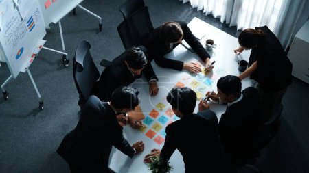 Photo for Top view of smart executive manager discuss and choose marketing idea from sticky notes. Group of business team talking and brainstorming strategy while making decision and choose plan. Directorate. - Royalty Free Image