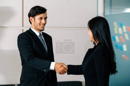 Photo for Business people agreement concept. Businessman and Asian businesswoman do handshake in the office. uds - Royalty Free Image