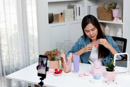 Photo for Young beautiful Asian reviewing cosmetic makeup brush cheek testing collection with pastel color, showing glow blusher mood with pink to promote on social media online recording smartphone. Stratagem. - Royalty Free Image