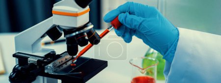 Photo for Laboratory researcher develop new medicine or cure using microscope. Technological advance of healthcare with scientific expertise with laboratory microbiology equipment. Panorama Rigid - Royalty Free Image