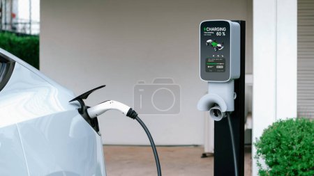 Photo for Electric vehicle technology utilized to residential home charging station for EV car battery recharge. Eco-friendly transport by clean and sustainable energy for future environment.Panorama Synchronos - Royalty Free Image