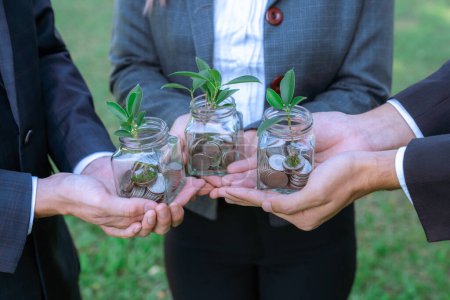 Concept de croissance durable de l'argent investissement avec bocal en verre rempli de pièces d'épargne avec les gens d'affaires que l'investissement financier respectueux de l'environnement nourri par la nature et une retraite saine. Pneumatique