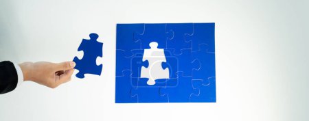 Photo for Panorama banner of business team assembling jigsaw puzzle over table symbolize business partnership and collective teamwork for HR recruitment and job seeker background. Shrewd - Royalty Free Image