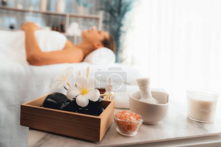 Photo for Aromatherapy massage on daylight ambiance or spa salon composition setup with focus decor and spa accessories on blur woman enjoying blissful aroma spa massage in resort or hotel background. Quiescent - Royalty Free Image