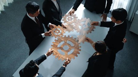 Photo for Top view of business people gather wooden cog together at meeting. Group of project manager helping and team working to solve problem at meeting room or workplace. Represent unity. Directorate. - Royalty Free Image